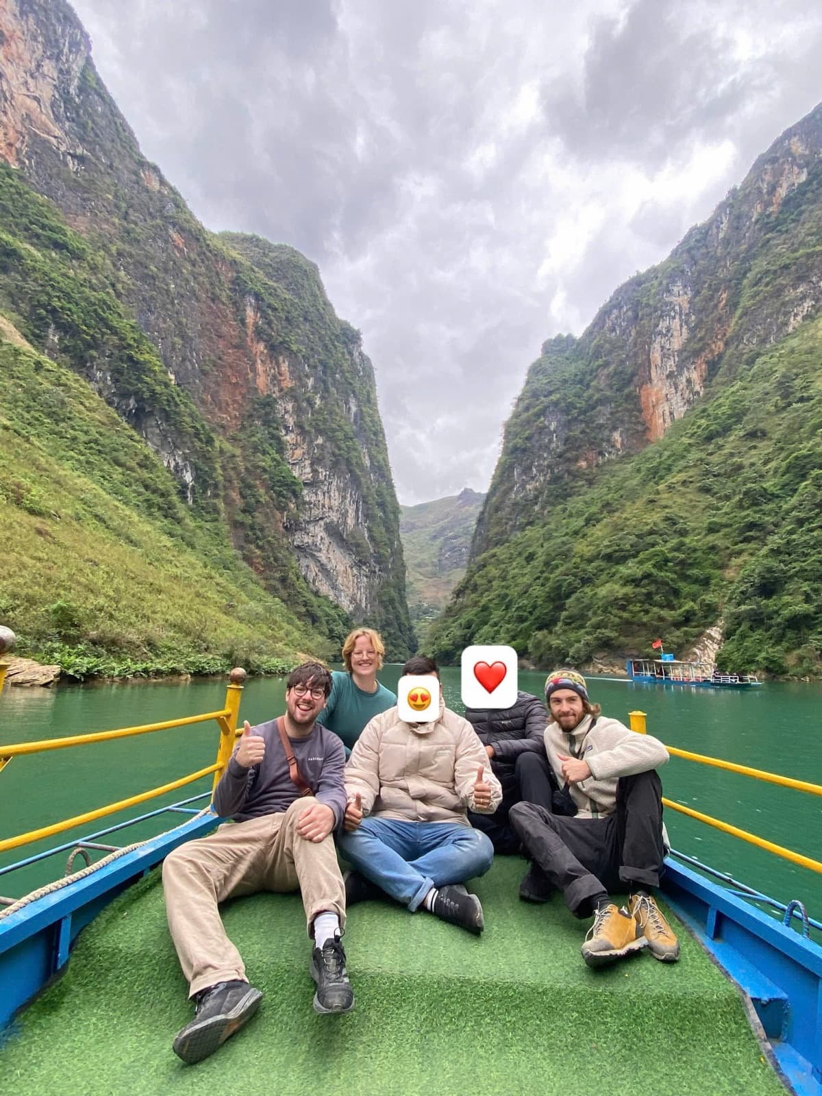 A group of guests on the boat between towering cliffs