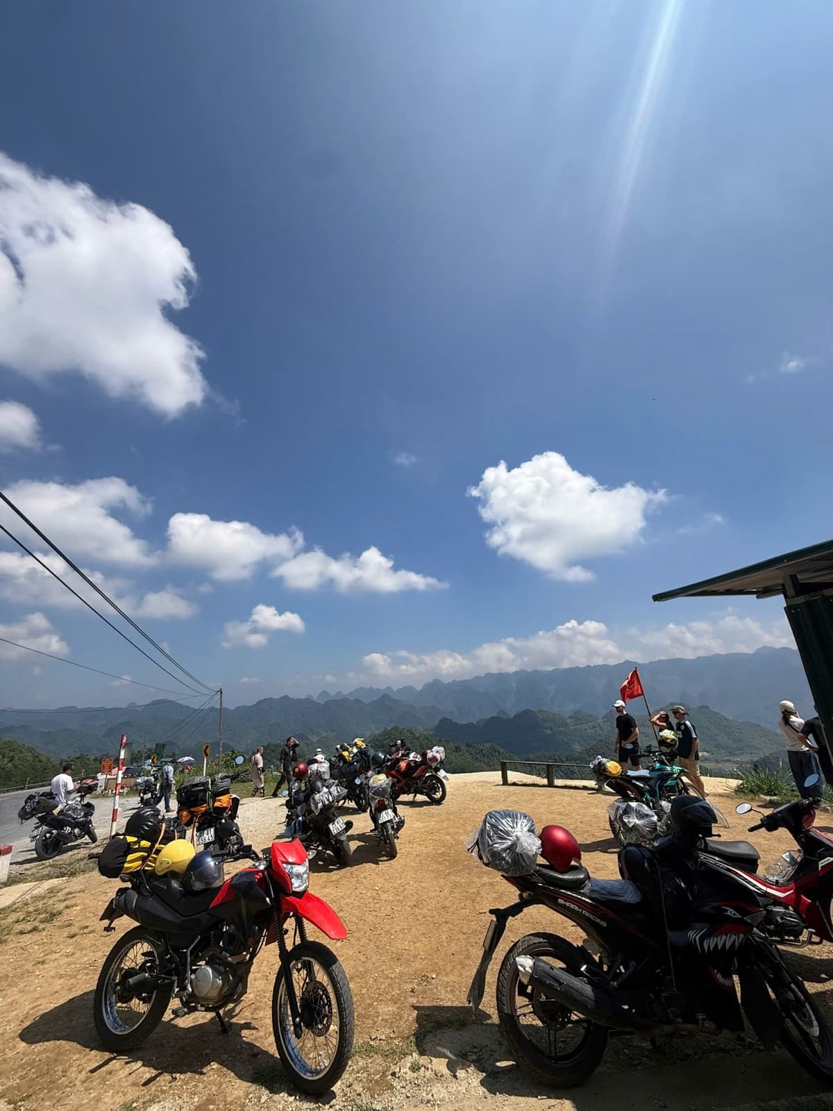 Our Wave and XR motorbikes lined up at a mountain viewpoint