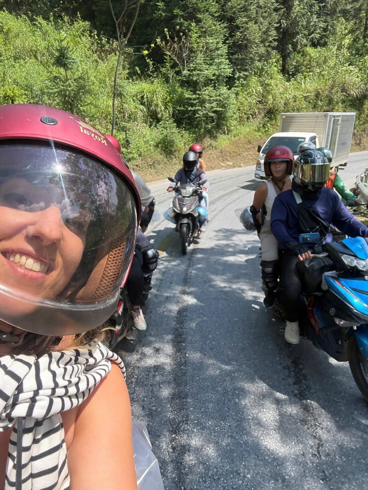 A smiling guest riding pillion with our Easy Riders on the Ha Giang Loop