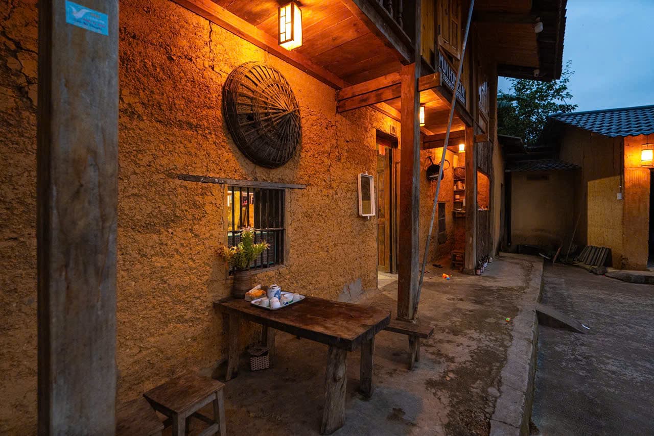A traditional rammed-earth house lit up in the evening