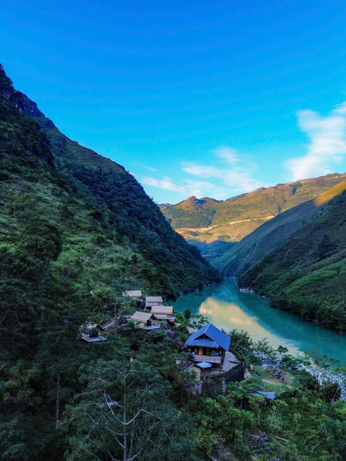A riverside homestay on the mountainside above a turquoise river